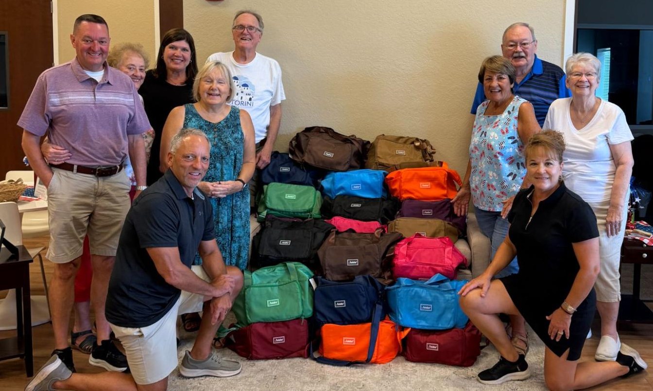 Grace Group members with colorful duffle bags prepared for foster children