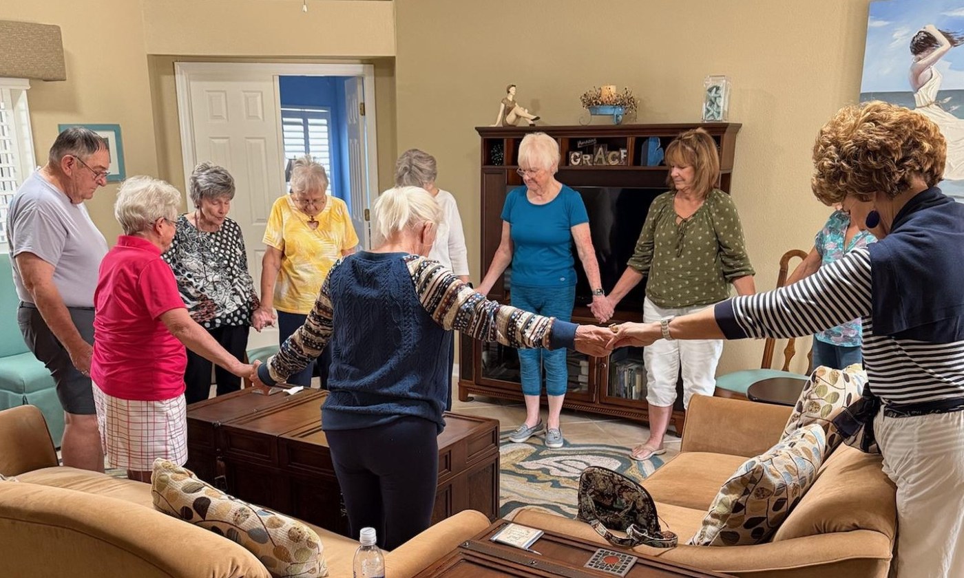 Grace Group members holding hands in prayer