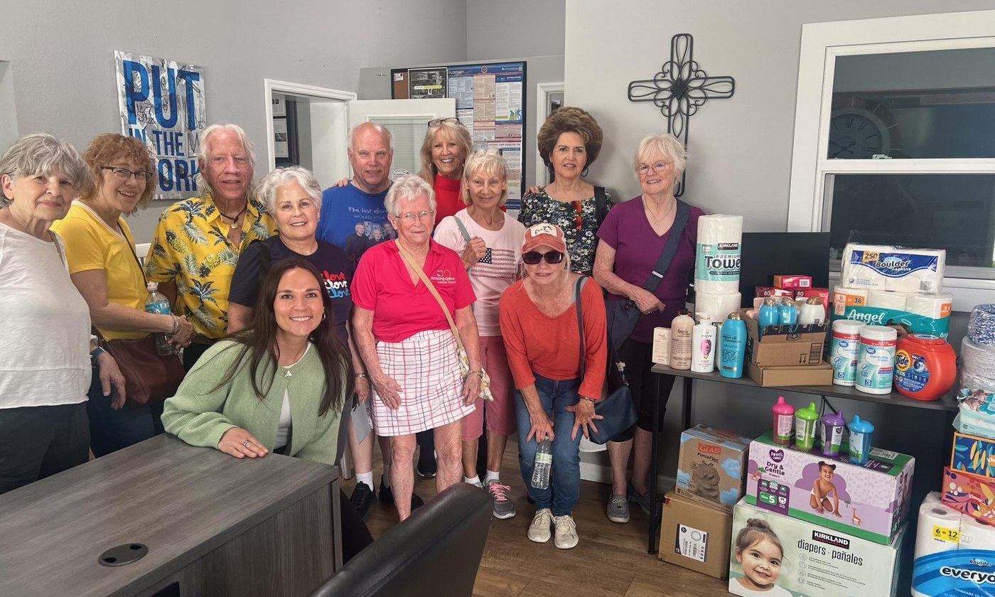 Grace Group members with donated household and personal-care supplies